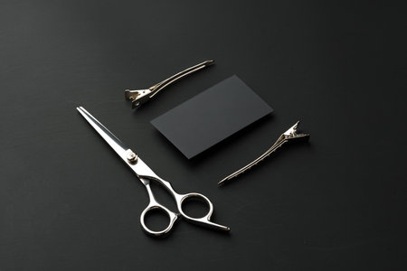 Hairdressing scissors and businesscard mock up on black background
