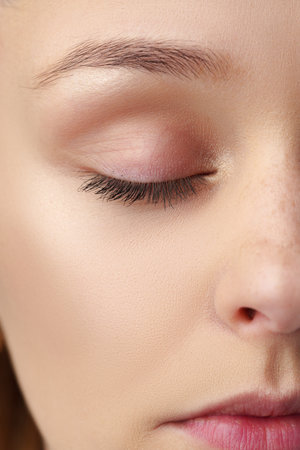 Close up of a young woman with nude make upの写真素材