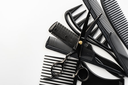 Black hairdressing tools and various hairbrushes on white backgroundの写真素材