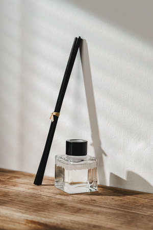 Elegant Perfume Bottle Bathed in Sunlight on a Wooden Surface