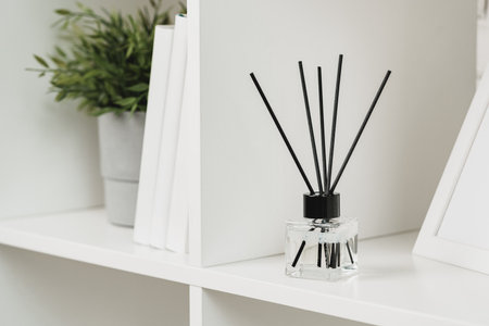 Elegant Reed Diffuser on White Shelf in a Modern Minimalist Interior Setting