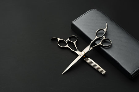 Hairdressing scissors with case on a black backgroundの写真素材
