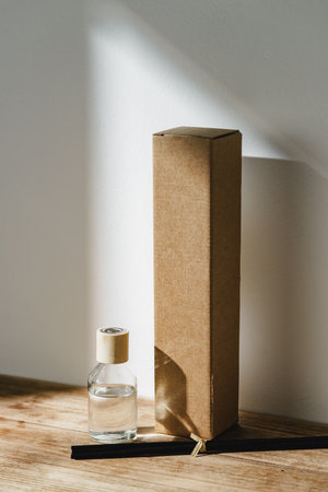 Elegant Reed Diffuser With Shadows on Wooden Surface in Soft Morning Lightの写真素材