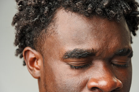 Close Up of African Mans Face With Brown Eyesの写真素材