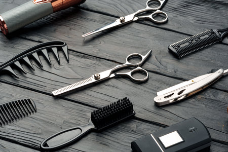 Professional Barber Tools Laid Out on Dark Wooden Surface