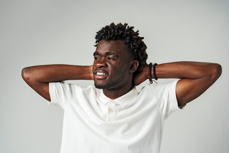 African Man Holding Head in Frustration in Studioの写真素材