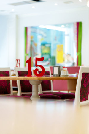 Vibrant Restaurant Interior With Red Number 15 on Table and Colorful Artwork in Backgroundの写真素材