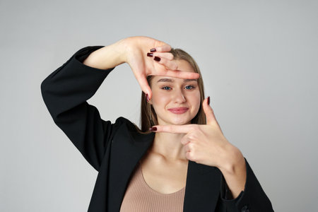 Woman Making a Camera Gesture With Her Fingersの写真素材