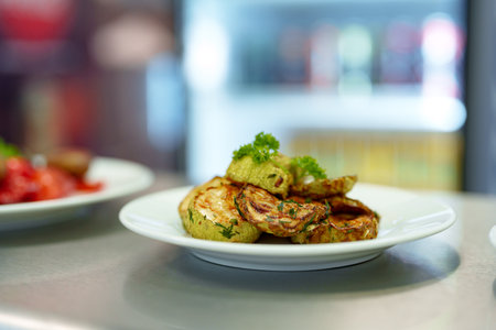 Grilled Zucchini Slices Served on a White Plate in a Modern Kitchen Settingの写真素材
