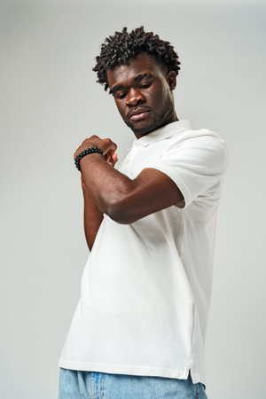 A man is standing and posing for a picture, with his fist raised in the air.の写真素材