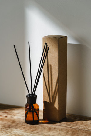 Elegant Reed Diffuser With Shadows on Wooden Surface in Soft Morning Light