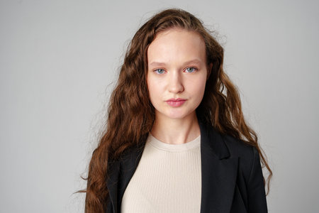Young Girl With Long Curly Hair Portraitの写真素材