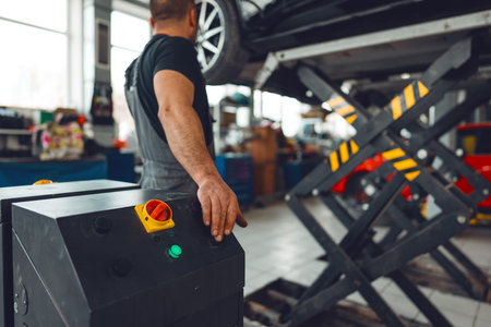 Auto mechanic is lifting car for repairing in car service