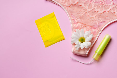 Womens panties with sanitary tampon on color backgroundの写真素材