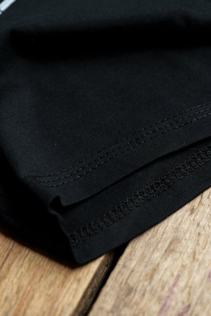 Black plain cotton t-shirt sleeve close up
