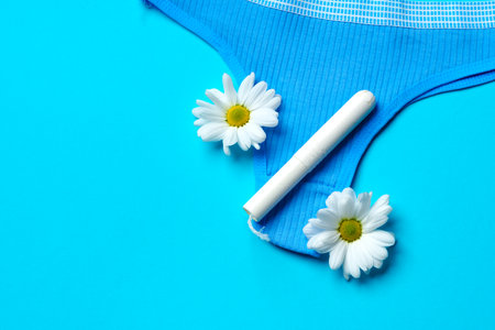 Womens panties with sanitary tampon on color backgroundの写真素材