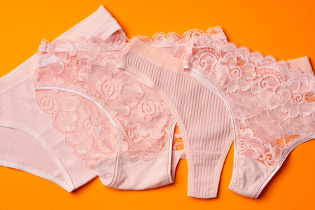 Womens panties on an orange background flat lay