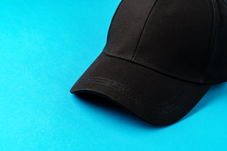 Baseball caps on blue background studio shot