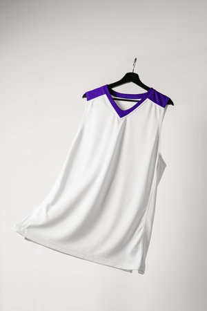 White basketball jersey hanging against white backgroundの写真素材