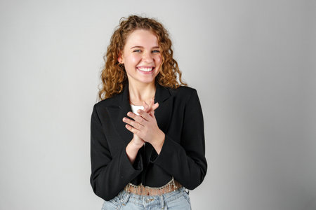 Young Woman With Curly Hair Portrait against gray background