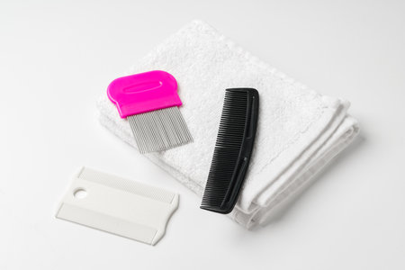 Anti lice combs and towel on white backgroundの写真素材