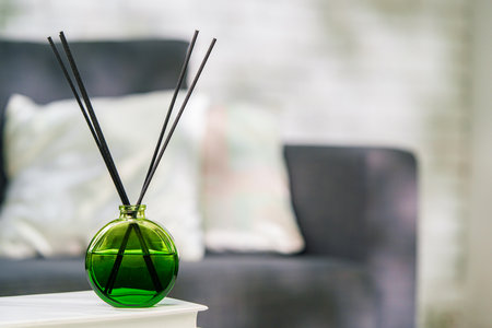 Aroma diffuser bottle with sticks in living roomの写真素材