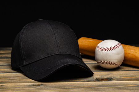 Baseball cap, ball and bat on wooden backgroundの写真素材