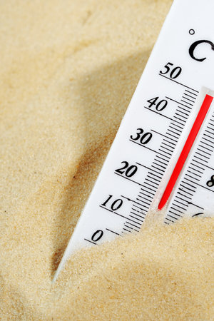 Thermometer Measuring High Temperature on Sandy Beachの写真素材