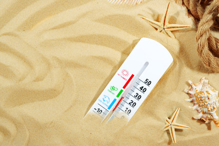 Thermometer Measuring Temperature on Sandy Beachの写真素材