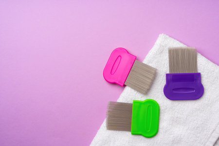Anti lice combs and towel on pink backgroundの写真素材