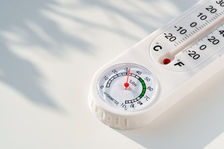 White Plastic Thermometer on a White Surface With Shadowの写真素材