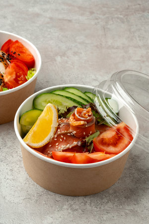 Tasty poke bowls on gray textured surfaceの写真素材