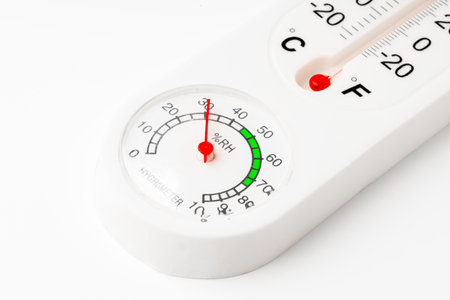 White Thermometer and Hygrometer Displaying Room Temperature and Humidityの写真素材