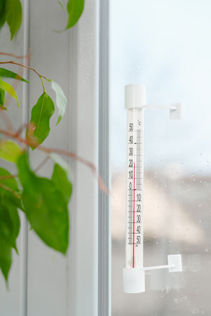 Celsius Thermometer on a Windowpane in a Home
