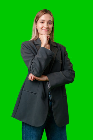 Woman In Black Blazer With Hands Crossed, Posing In Front Of Green Screenの写真素材