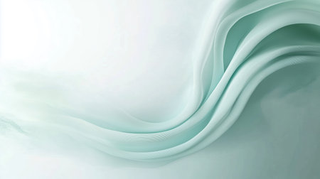 Soft mint fabric drapes gracefully on a light surface, creating a soothing and gentle flow in a serene settingの素材