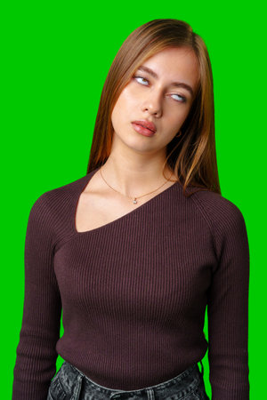 Young Woman Wearing Burgundy Sweater Looks Away From Cameraの写真素材