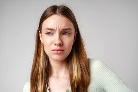 Young Woman With Frowning Expression in Portraitの写真素材