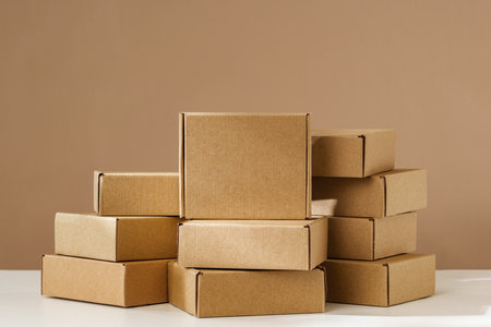 Stacked Brown Cardboard Boxes on White Surface