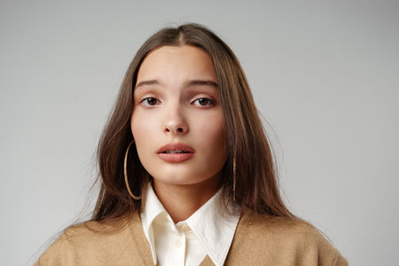 Emotional worried young female in casual clothes