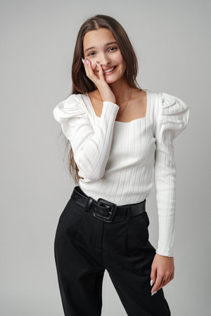 Young Woman Posing Against a White Background