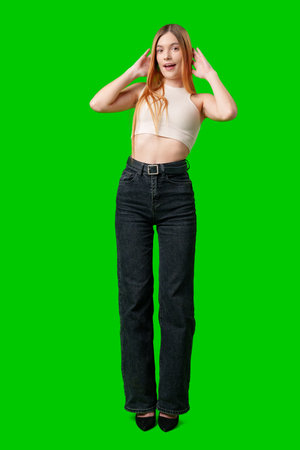 Young Woman With Surprised Expression in Front of Green Screenの写真素材