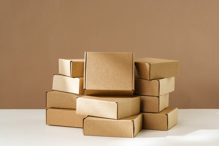 Stacked Brown Cardboard Boxes on White Surface