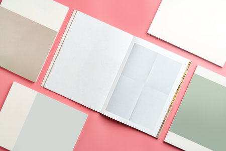 A Collection of Blank Papers Stacked on a Pink Surface for Creative Projectsの写真素材