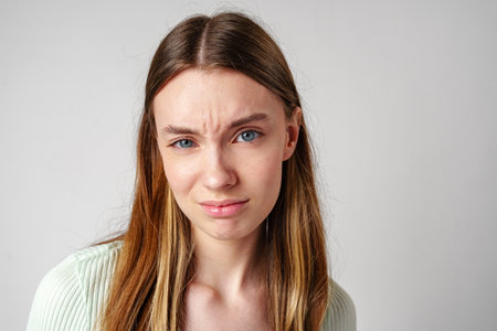 Portrait of Young Woman With Frowning Expression
