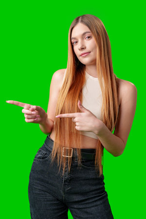 Young Woman With Long Hair Pointing To Copy Spaceの写真素材