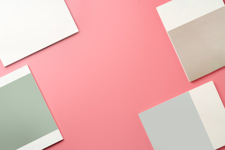 A Collection of Blank Papers Stacked on a Pink Surface for Creative Projectsの写真素材