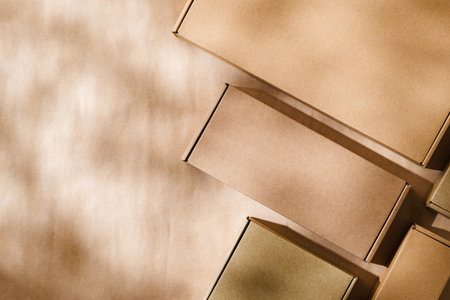 Brown cardboard boxes arranged on a neutral background in a warehouse setting during daylight hoursの写真素材