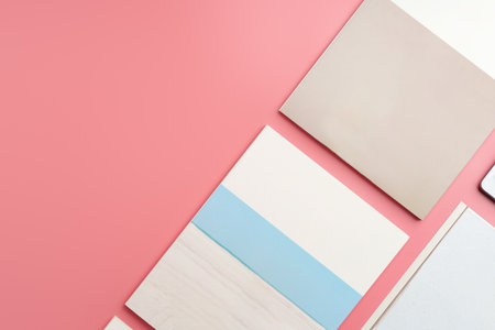 A Collection of Blank Papers Stacked on a Pink Surface for Creative Projectsの写真素材
