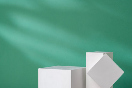 Simple geometric shapes on a teal background with soft lightingの写真素材